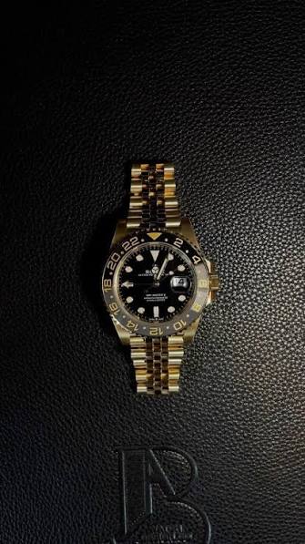 Gold GMT timepiece on leather