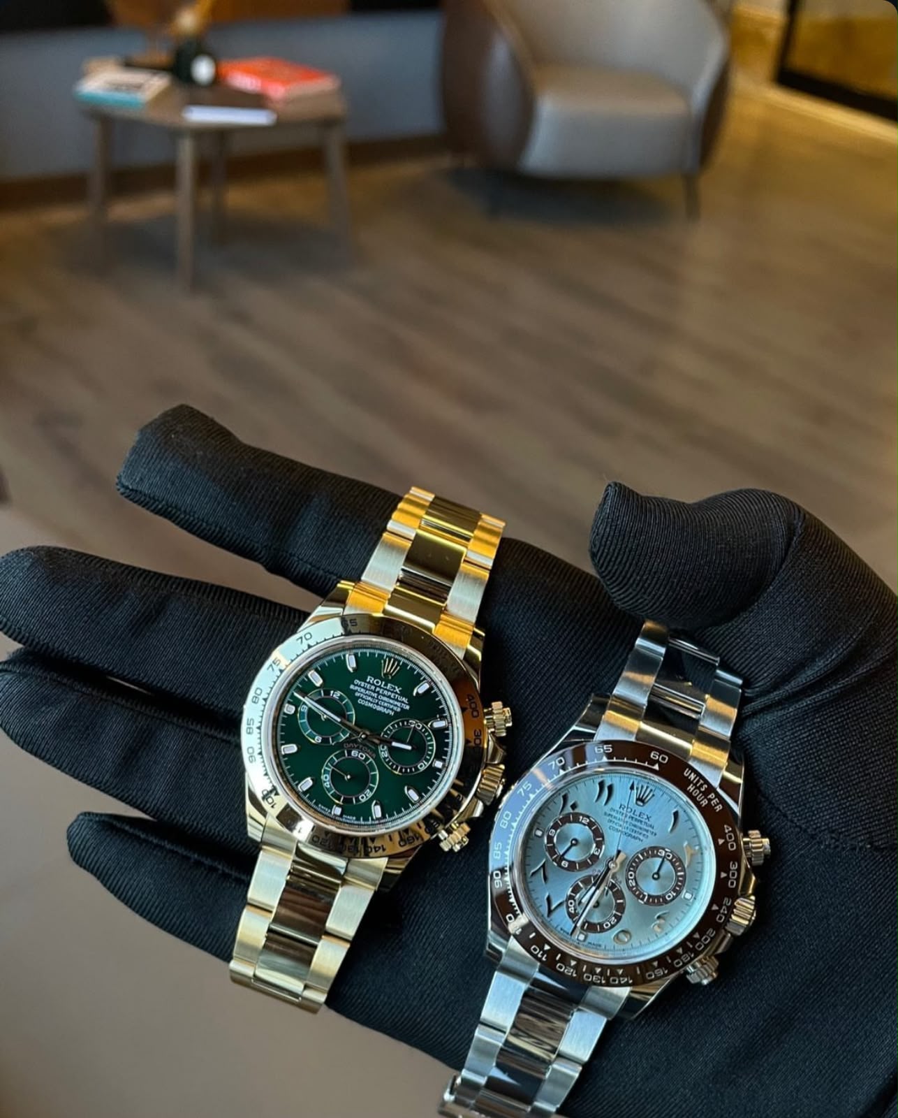 Two luxury chronographs held in gloved hands